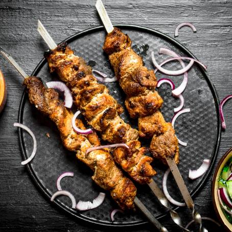 Shish Kebab Pieces with Green Salad on White Plate Delicious Meat Dish for Lunch or Dinner