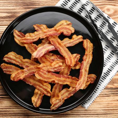 Single Crispy Bacon Slice on Plain White Background