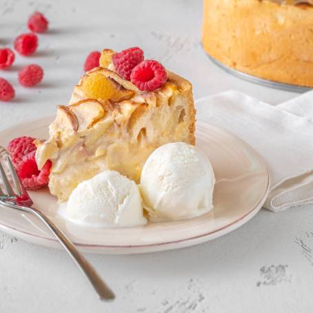 Slice of Pie with Vanilla Ice Cream Scoop on White Background