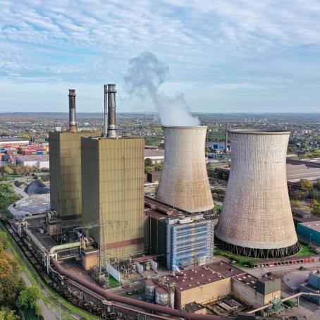 Smoke and Chimneys in Twilight Mining Landscape