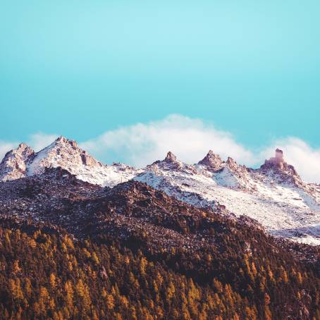 Snowy Alpine Peaks at Sunset Winters Warm Glow