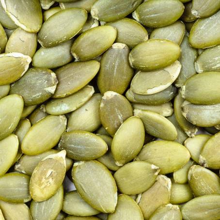 Stack of Hulled Pumpkin Seeds White Background CloseUp