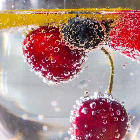 Strawberry and Bubbles in Sparkling Water Close Up View