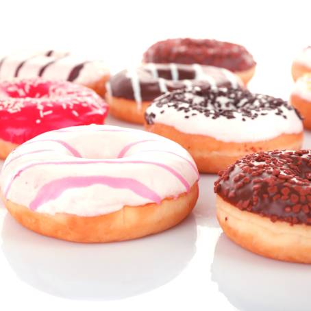 Strawberry Glazed Donuts with Fun Sprinkles on White Surface