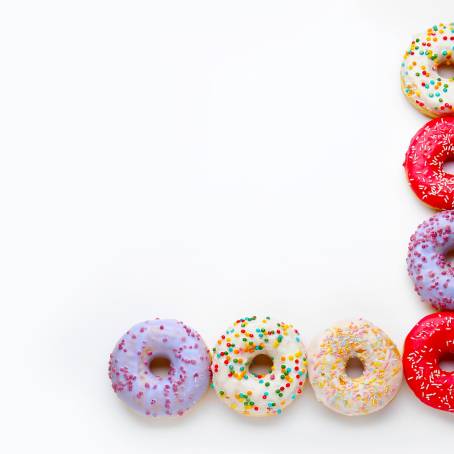 Strawberry Glazed Donuts with Sprinkles on Bright White Background