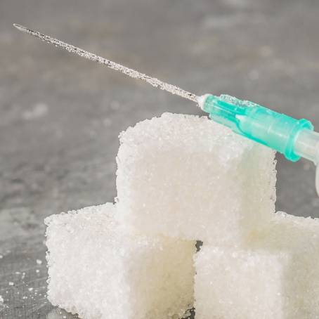 Sugar Cubes on Dark Surface Unhealthy Nutrition Leading to Obesity, Diabetes, and Dental Issues