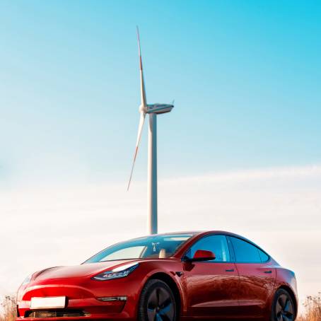 Sunny European Road Red Car Driving Through Scenic Mountain Landscape