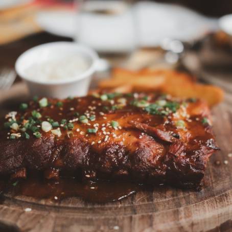 Tender Grilled Ribs with Rich and Smoky Barbecue Glaze on a Carving Board