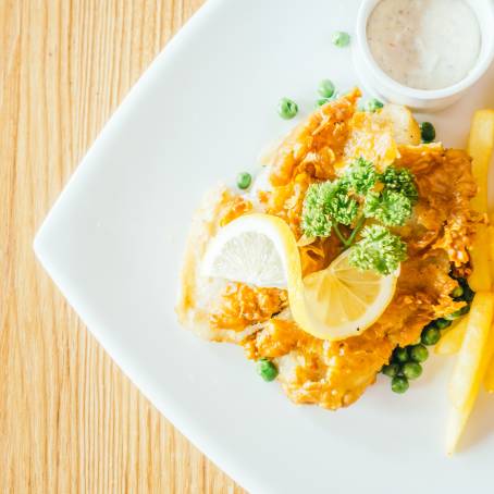 Top Down View of Fish and Chips with Golden Crispy Finish on White Plate