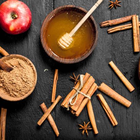 Top View Cinnamon Sticks and Powder on White Plate