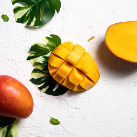 Top View of Fresh Yellow Mango on a White Background, Perfect for Tropical Fruit Backgrounds