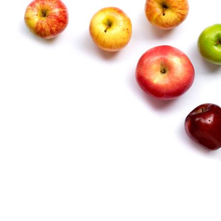 Top View of Red Apples and Slices in a White Bowl on Black Background