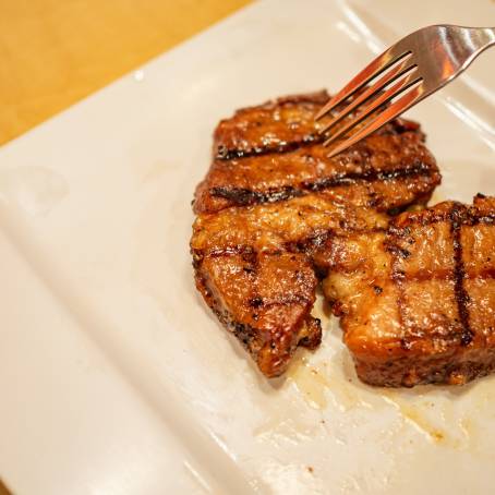 TopDown Image of Grilled Pork on White Background Ideal for Food Photography and Displays