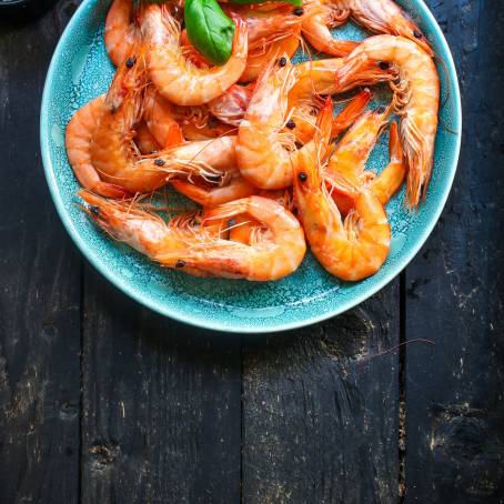 TopDown View of ReadytoEat Grilled Prawns on Black Plate Ideal for Food Menus