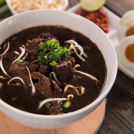 Traditional Rawon Indonesian Black Beef Soup with Rice and Accompaniments