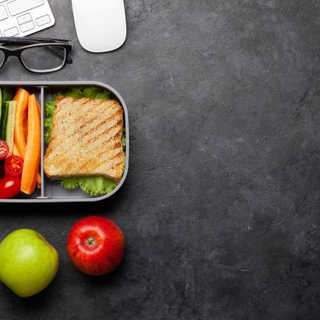 Vibrant Lunch Box with Sandwich, Carrots, and Salad