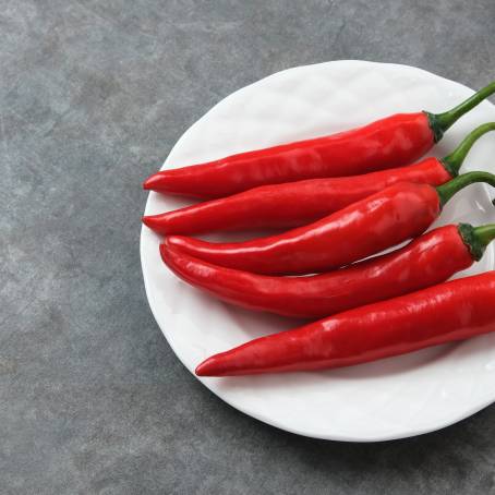 Vibrant Red Cayenne Pepper Isolated on White Spicy and Hot