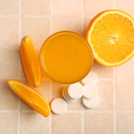 Vitamin C Dissolving in Water Close Up of Orange Effervescent Drink