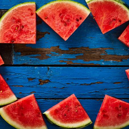 Watermelon Slice on Blue Background, Fresh and Juicy Summer Fruit, Close Up Photography, Vibrant