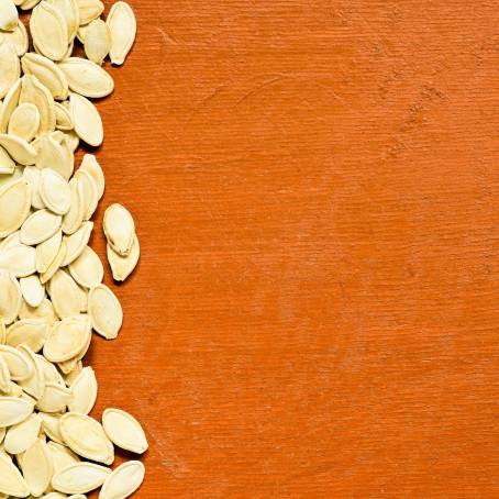 White Background with Stack of Hulled Pumpkin Seeds