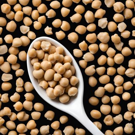 White Ceramic Spoon Filled with Chickpeas Isolated on Black High Detail Food Photography