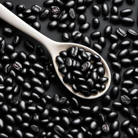 White Ceramic Spoon with Black Beans Isolated on Black Background Close Up Food Photography