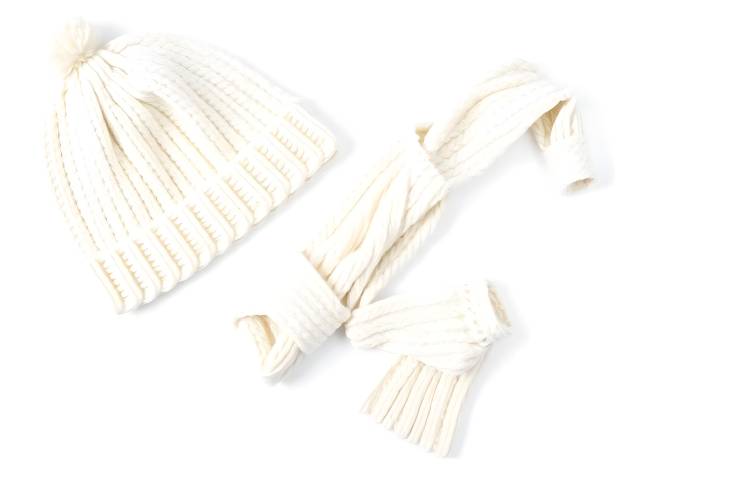 White Knitted Hat, Scarf, and Gloves Cozy Winter Accessories Isolated on White Background