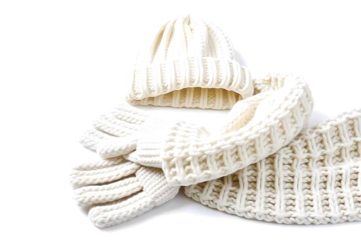 White Knitted Hat, Scarf, and Gloves Set Cozy and Stylish Winter Wear Isolated on White